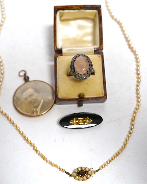 A marcasite ring, a pearl necklace, the garnet and split pearl clip, stamped 9ct, a black onyx and split pearl brooch and a 9ct gold photo pendant frame. Condition - fair